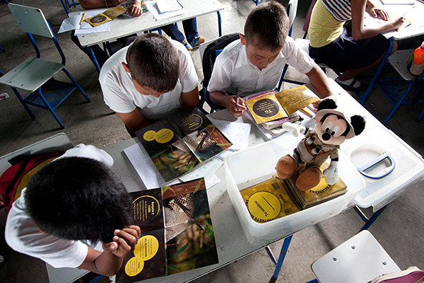 Students reading awareness information provided by Disney Wildlife Fund